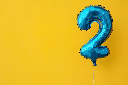 Blue Foiled Balloon Elegance on a Soft Yellow Background.の素材