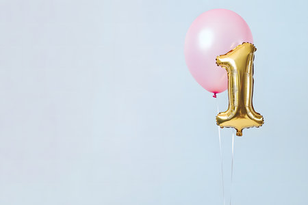 Pastel colors, the letter "1" from a gold foil balloon on a white minimalist background with space for text.の素材