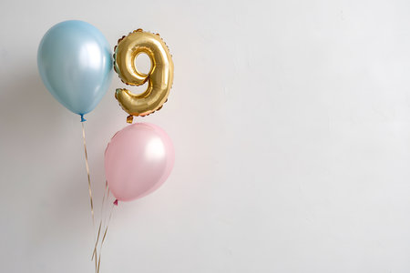 Pastel colors, the letter 9 from a gold foil balloon on a white minimalist background with space for text.の素材