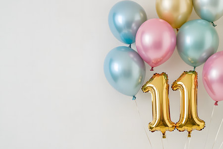 Pastel colors, the letter 11 from a gold foil balloon on a white minimalist background with space for text.の素材