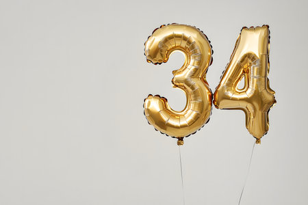 Stylish Gold Foil Balloon '34' with Space for Custom Text.の素材