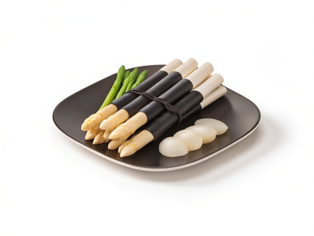 asparagus and garlic on a plate isolated on a white backgroundの写真素材