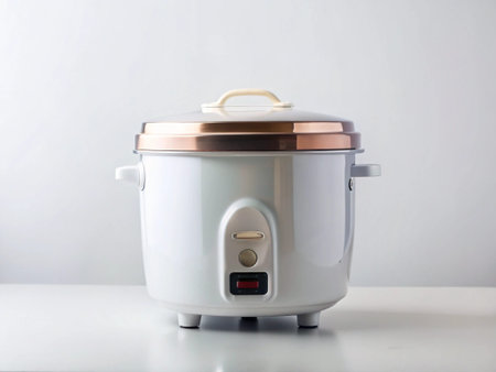 Modern electric rice cooker on white table against white background. Copy space.の写真素材