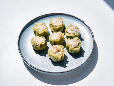 Chinese steamed dumpling dim sum on a plate with white background