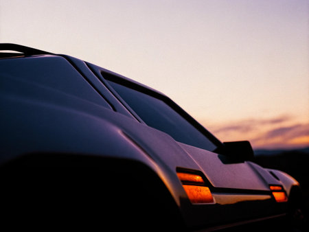 Car on the road at sunset. Close-up of a car.