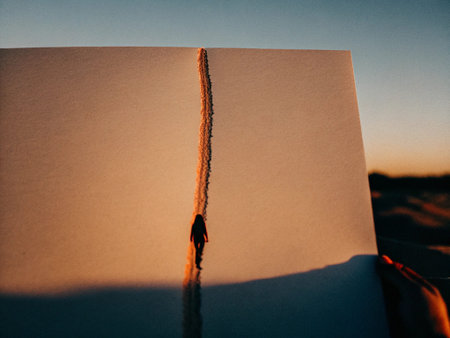 Blank paper with shadow of a man in the desert at sunset