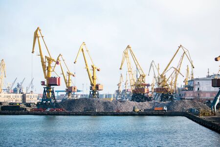 Heaps of stone under cranes at the loading area in the port - Ukraine, Odessa, 09,11,2019のeditorial素材