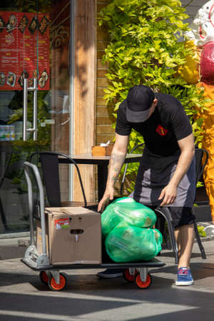 Cafe worker unloads groceries - Ukraine, Odessa, 11,06,2020のeditorial素材