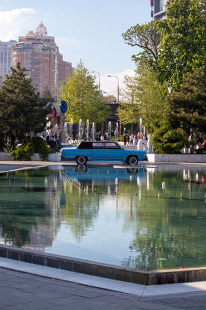 Blue retro car by the fountainのeditorial素材