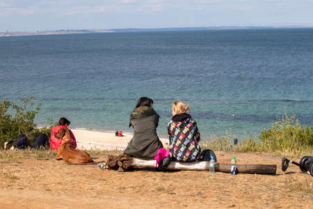 People and dog rest by the seaのeditorial素材
