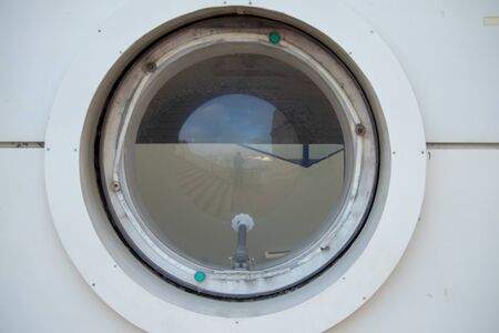 Round window in the port buildingの写真素材