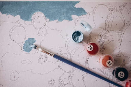 Drawing a picture by numbers with paints. Coloringの写真素材