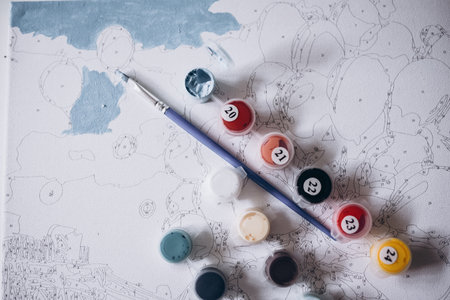 Drawing a picture by numbers with paints. Coloringの写真素材