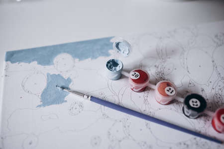 Drawing a picture by numbers with paints. Coloringの写真素材
