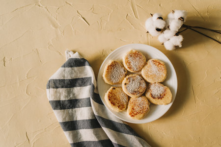Cottage cheese pancakes or syrniki with on ceramic plate.Delicious breakfast or brunch