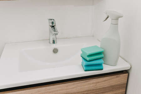 person washing hands in the bathroom. green glovesの写真素材