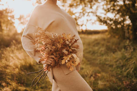 pregnant girl in nature. Autumn forest. pregnant bellyの写真素材