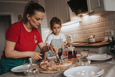 mom and daughter are making pizza. Familyの写真素材