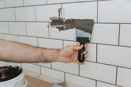 grouting tiles in the kitchen. repair. tile hogの写真素材