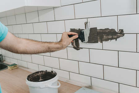 grouting tiles in the kitchen. repair. tile hogの写真素材