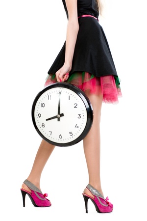 female legs. Woman holding wall clockの写真素材