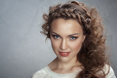 Woman curly hair on a gray backgroundの写真素材