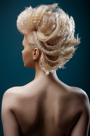 Beautiful young woman with short haircut on studio backgroundの写真素材