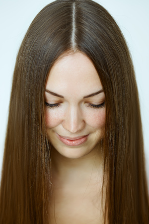 Portrait close up of young beautiful woman with straight hairの写真素材