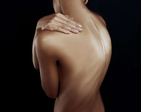 Female hand on her shoulderの写真素材