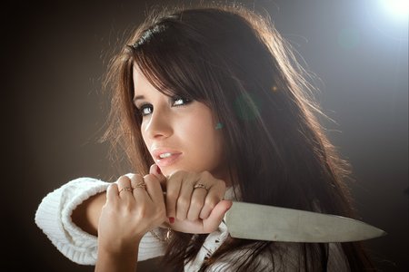 Gorgeous woman with knife in her hand close-upの写真素材