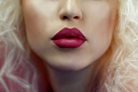 Close up shot of the full lips young blonde girl. Studio shotの写真素材