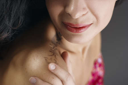 Close up shot of the full lips young brunette womanの写真素材