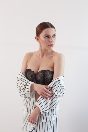 attractive woman in in lingerie covering her big breastの写真素材