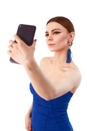 Portrait of a cheerful smiling woman taking selfieの写真素材