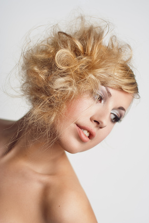 Portrait of a young woman with blond curly hairの写真素材