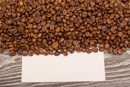 Coffee beans and blank for text on wooden backgroundの写真素材