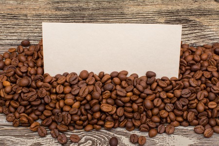 Coffee beans and blank for text on wooden backgroundの写真素材