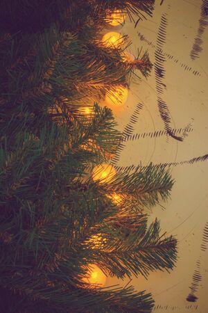 Lighted candles and fir branch on wooden boardsの写真素材