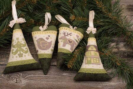 Handmade fabric heart and tree, fir branch on wooden backgroundの写真素材