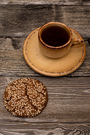 Small cup of coffee, cookies with sesame seeds on wooden backgroundの写真素材