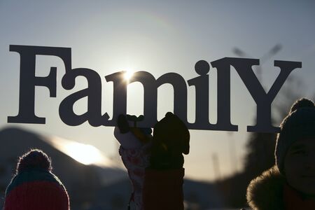 Couple in caps holding a plate familyの写真素材