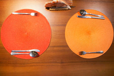 Table setting on wooden table in a restaurantの写真素材