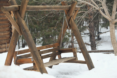Photo wooden swing in the forest in winterの写真素材