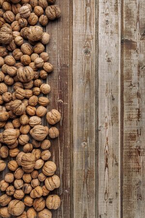 Walnuts on old vintage wooden background. Wood boards. Natural wood. Rustic style. The view from the top. Space for text.の写真素材