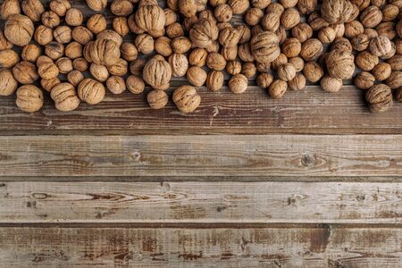 Walnuts on old vintage wooden background. Wood boards. Natural wood. Rustic style. The view from the top. Space for text.の写真素材