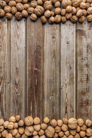 Walnuts on old vintage wooden background. Wood boards. Natural wood. Rustic style. The view from the top. Space for text.の写真素材