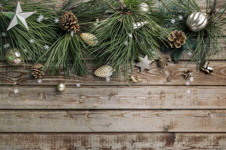 Christmas background. Spruce and pine branches with shiny balls on a wooden old vintage Board background. Christmas toy. Christmas. The view from the top. Christmas decorations.の写真素材