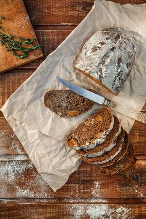 Freshly baked wheat bread, homemade cakes, still life with bread, crisp loaf of bread, still life on a rustic background, top view, rustic bread, roll, loaf. の写真素材