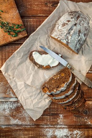 Freshly baked wheat bread, homemade cakes, still life with bread, crisp loaf of bread, still life on a rustic background, top view, rustic bread, roll, loaf. の写真素材
