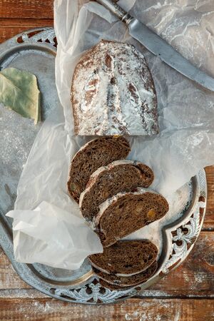 Freshly baked wheat bread, homemade cakes, still life with bread, crisp loaf of bread, still life on a rustic background, top view, rustic bread, roll, loaf.の写真素材